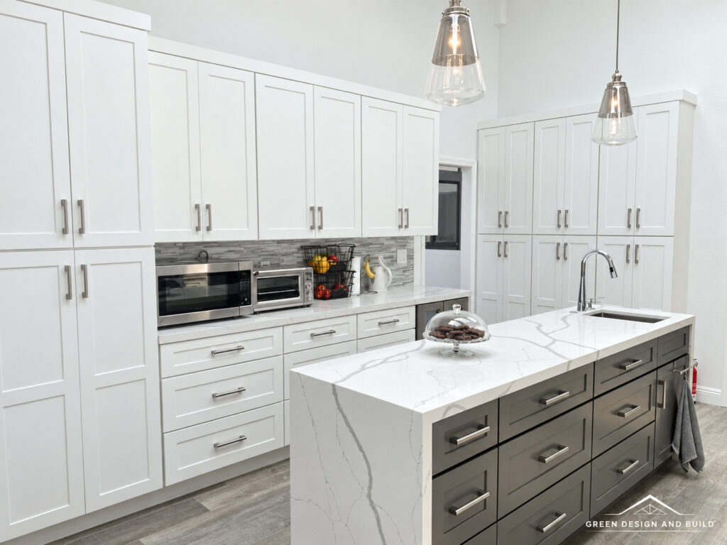 White shaker cabinets running to the ceiling beside a second prep island in a Burbank kitchen