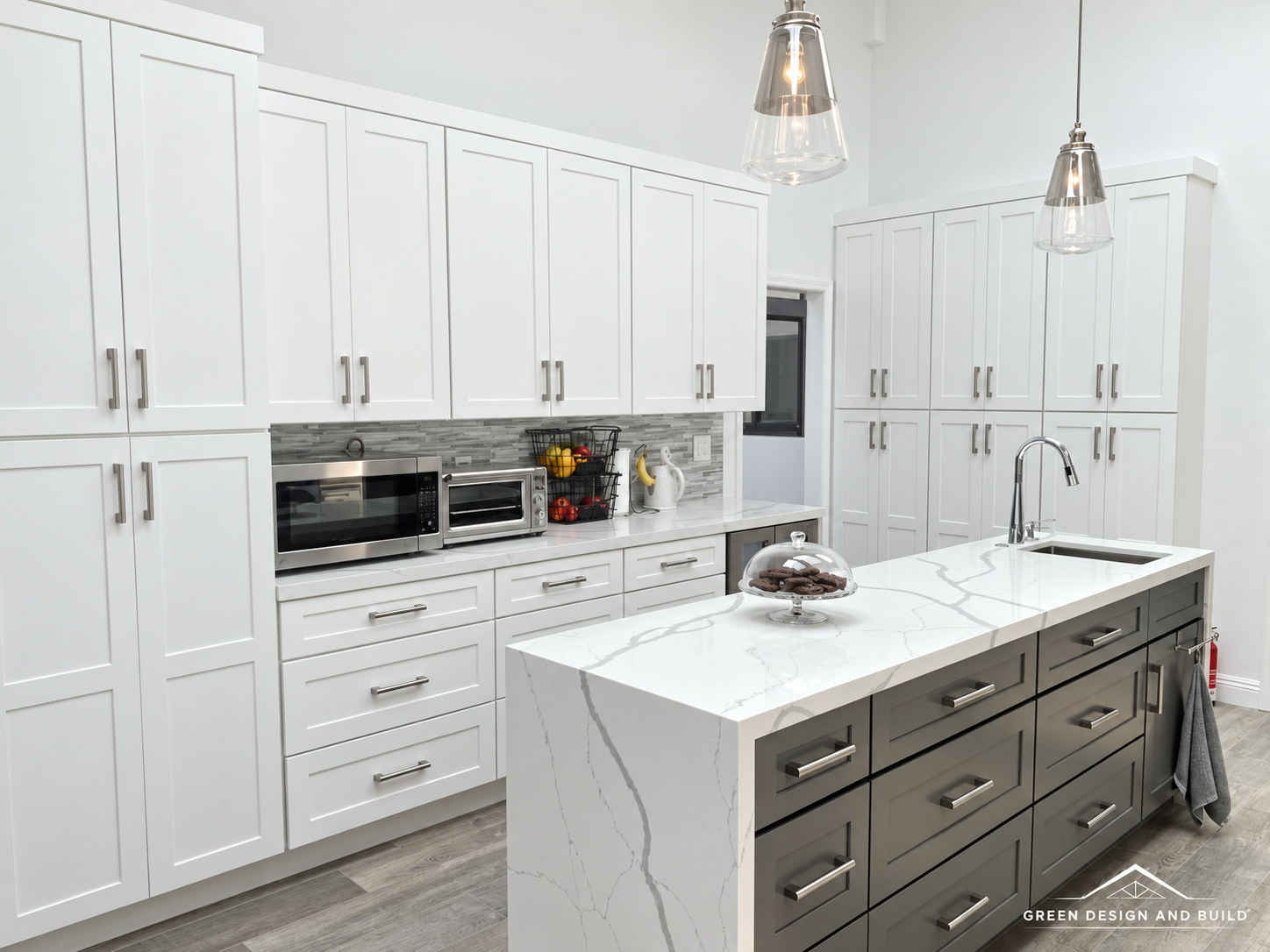 White shaker cabinets running to the ceiling beside a second prep island in a Burbank kitchen