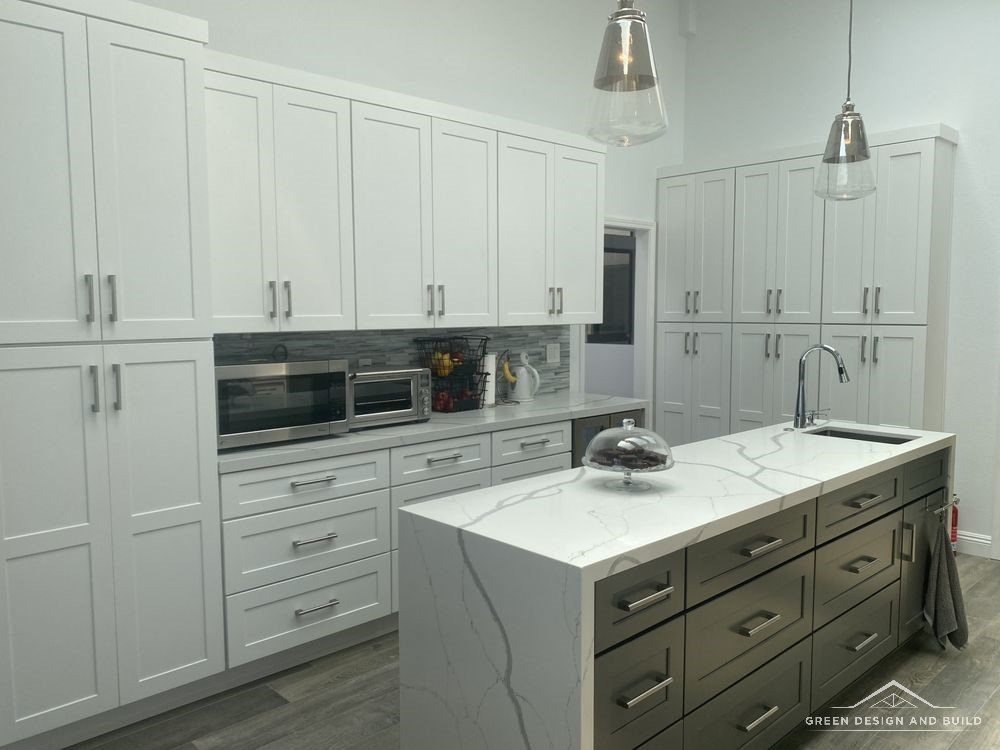 White shaker cabinets running to the ceiling beside a second prep island in a Burbank kitchen