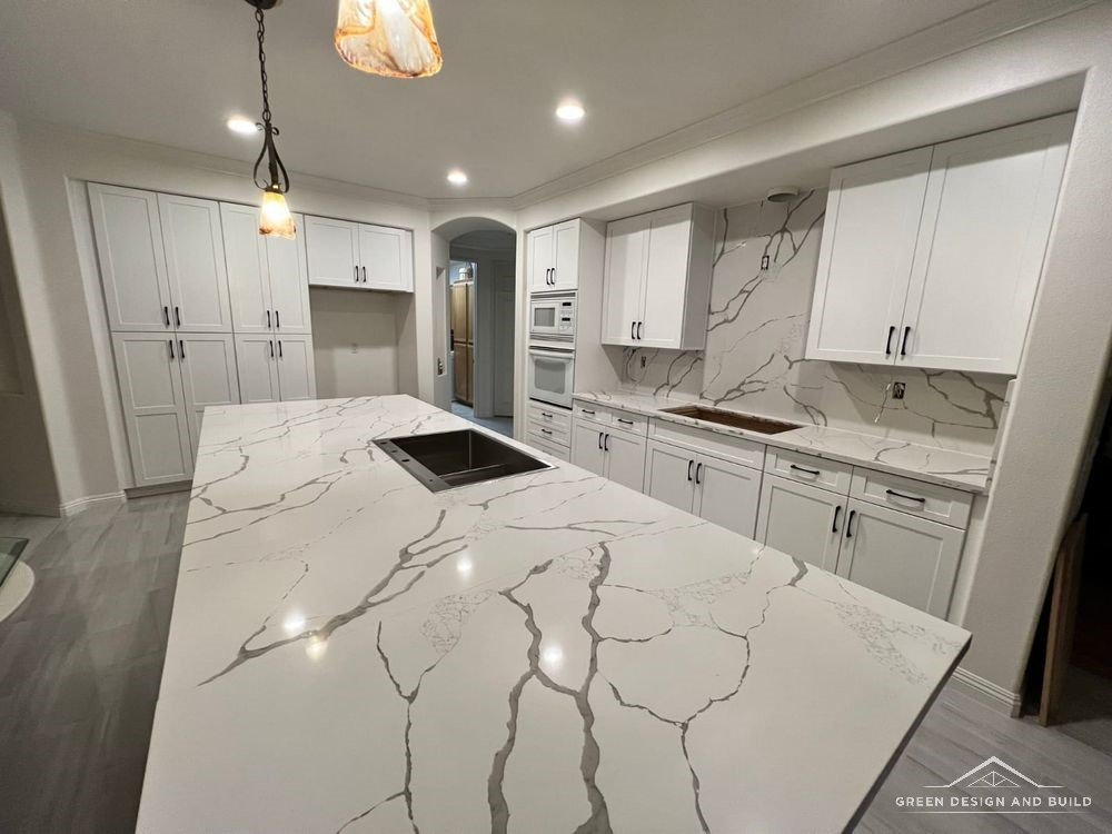 Professional range under a plaster hood with a linear tile backsplash in a Burbank kitchen