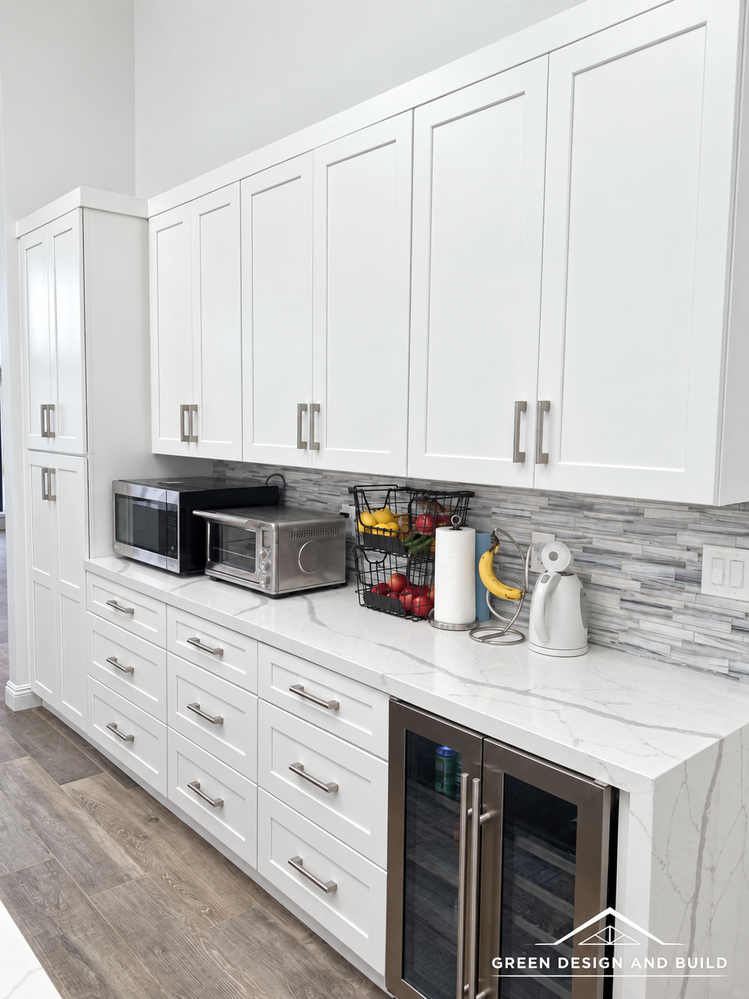 White cabinet run with a built-in wine fridge and quartz counter in a Burbank kitchen