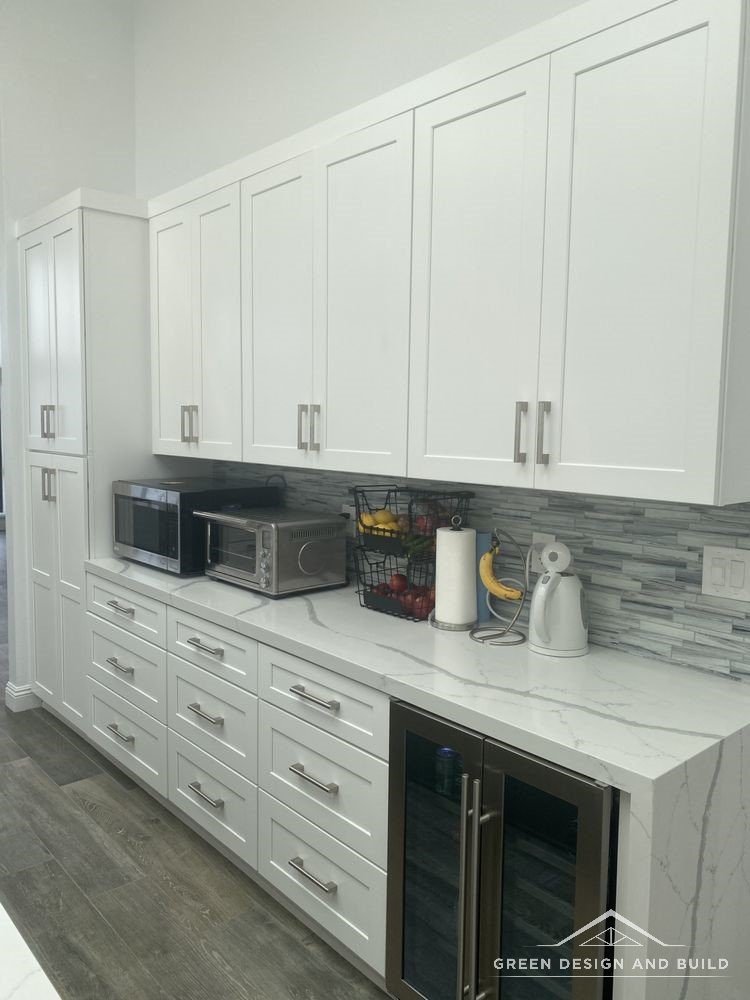 White cabinet run with a built-in wine fridge and quartz counter in a Burbank kitchen