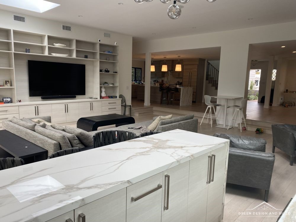 Open-plan kitchen looking across to a built-in media wall in a Burbank home