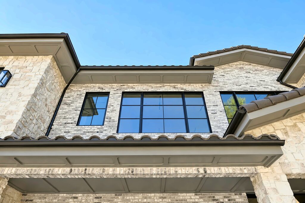 Clay barrel tile roof eave with boxed rafter tails on a Hidden Hills house