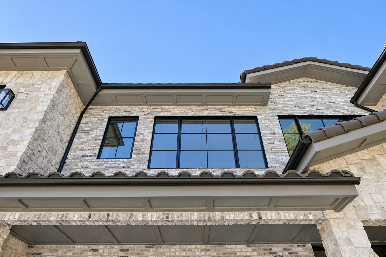 Clay barrel tile roof with boxed eave, fascia detail and half-round gutter on a Hidden Hills home