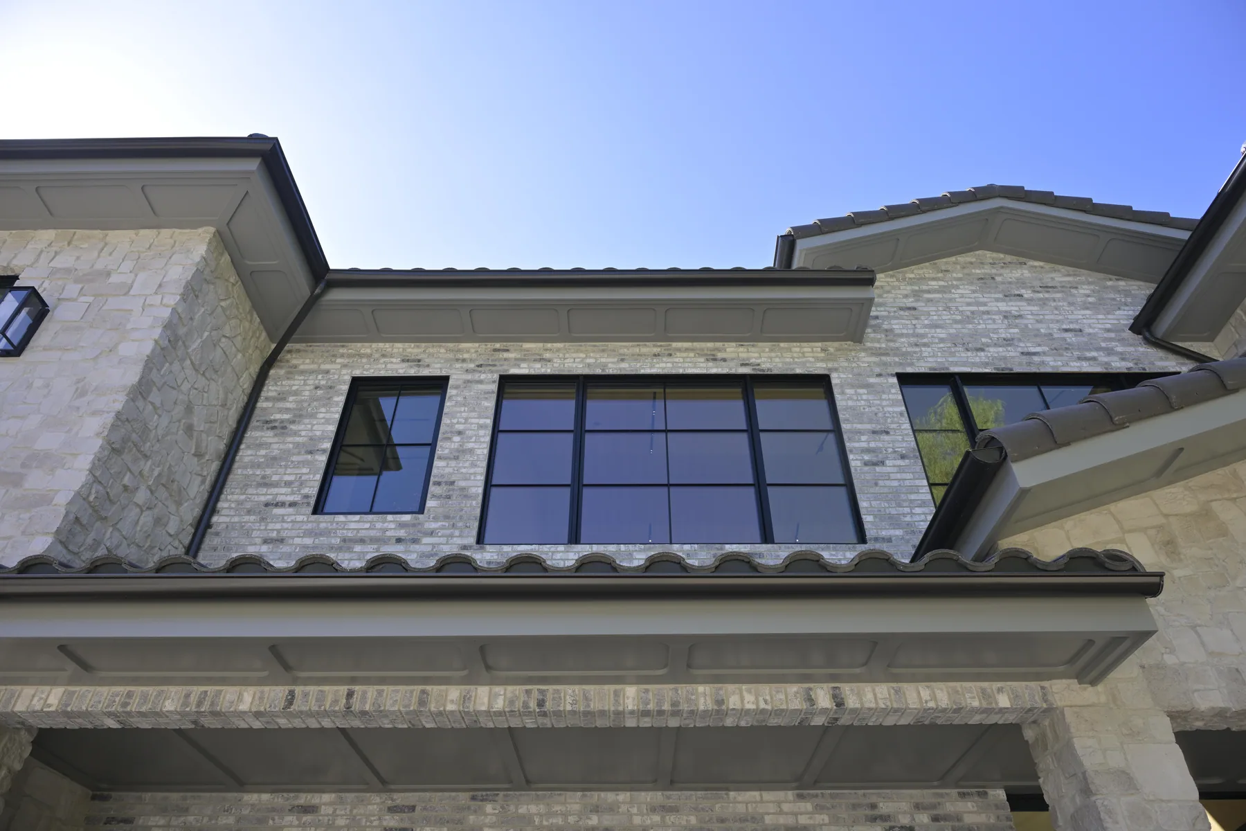 Clay barrel tile roof with boxed eave, fascia detail and half-round gutter on a Hidden Hills home