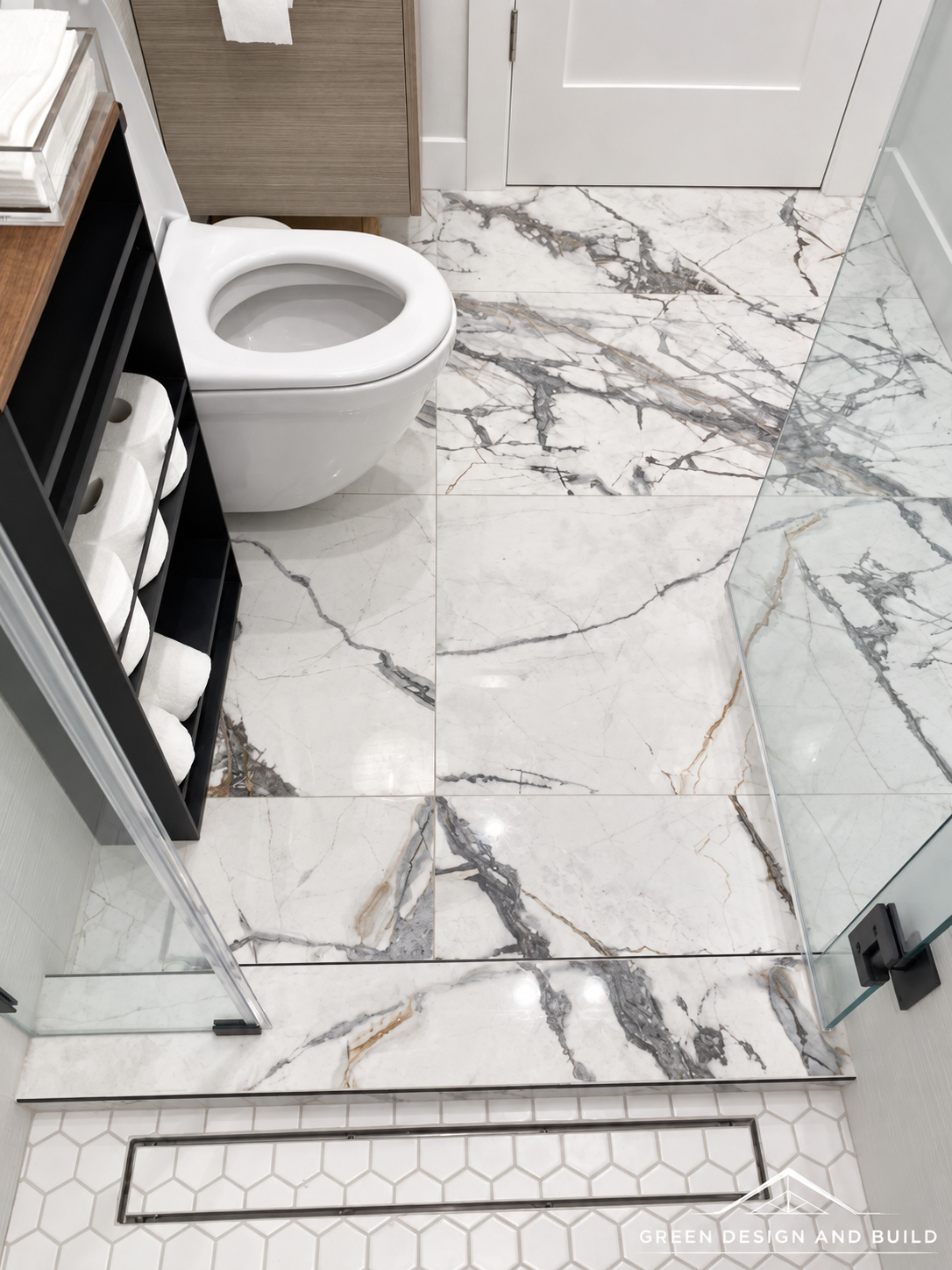 Linear shower drain set flush into large-format marble floor tile in a Diamond Bar bathroom