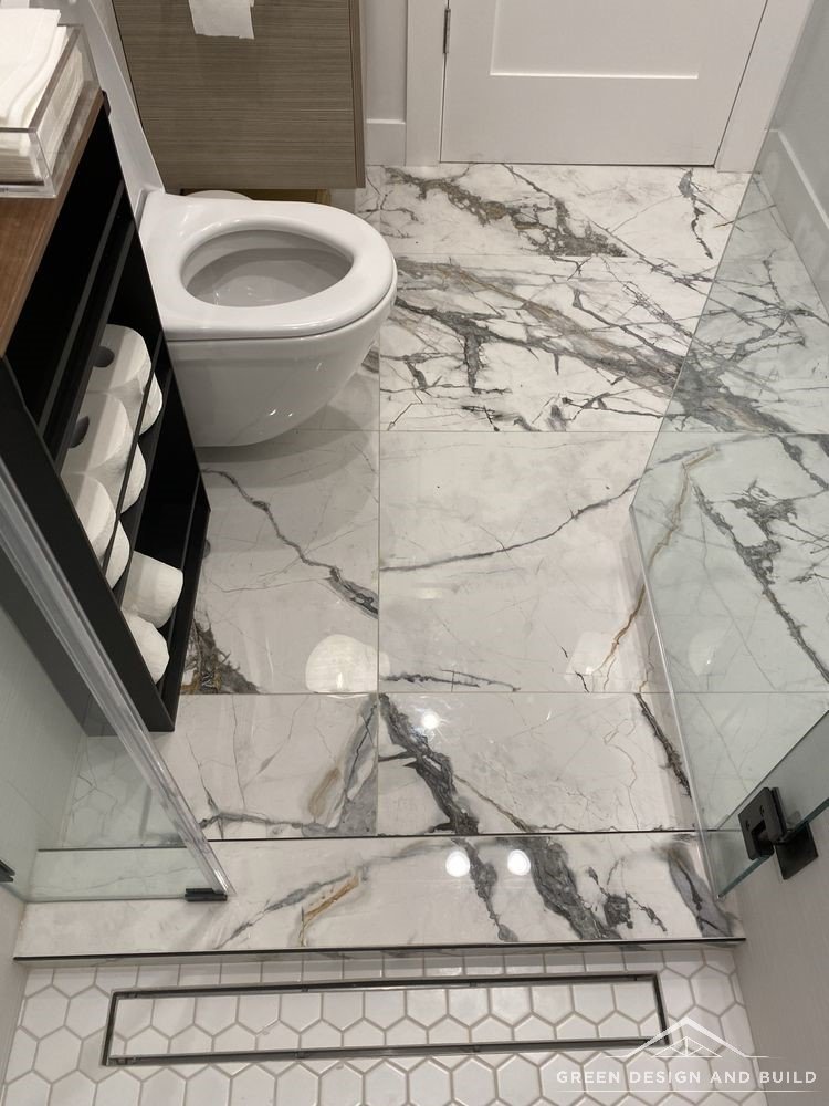 Linear shower drain set flush into large-format marble floor tile in a Diamond Bar bathroom