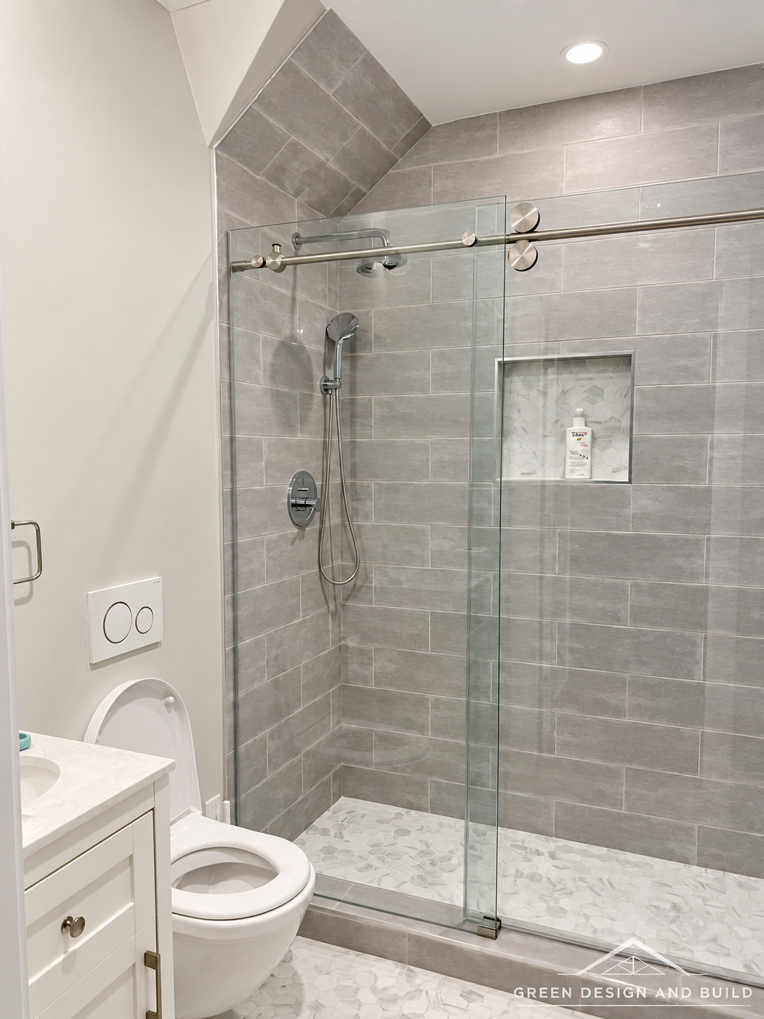 Tiled walk-in shower behind sliding glass doors with brushed hardware in a Diamond Bar bathroom