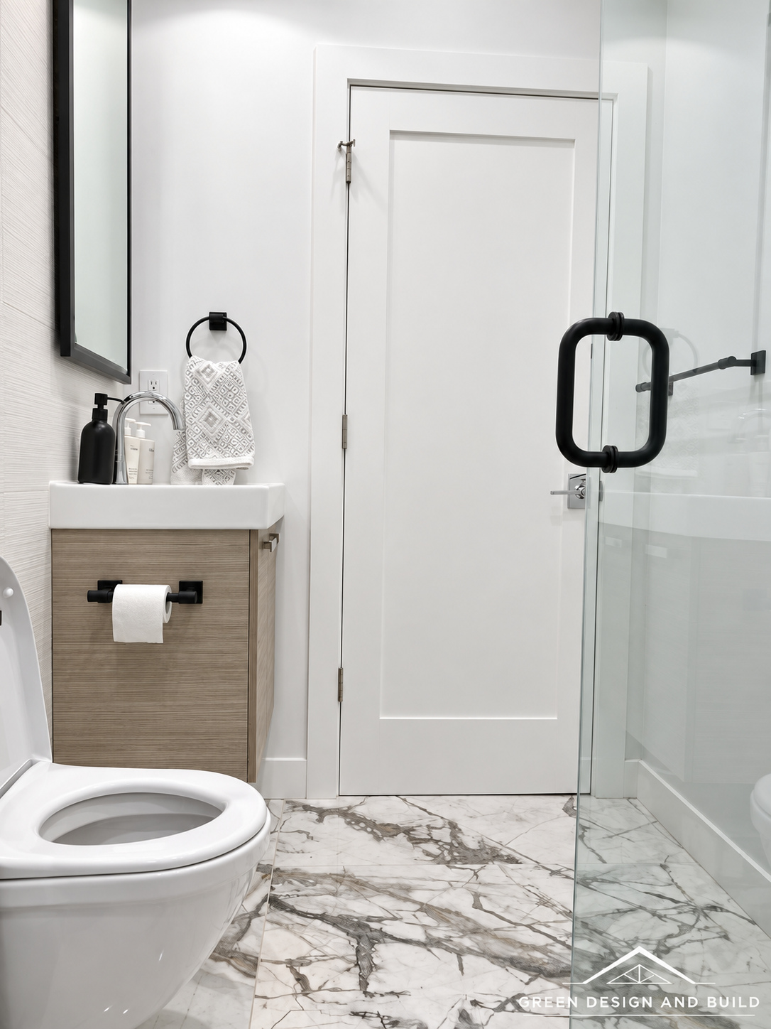Compact bathroom with a wall-hung vanity, mirror and frameless glass shower door in a Diamond Bar home