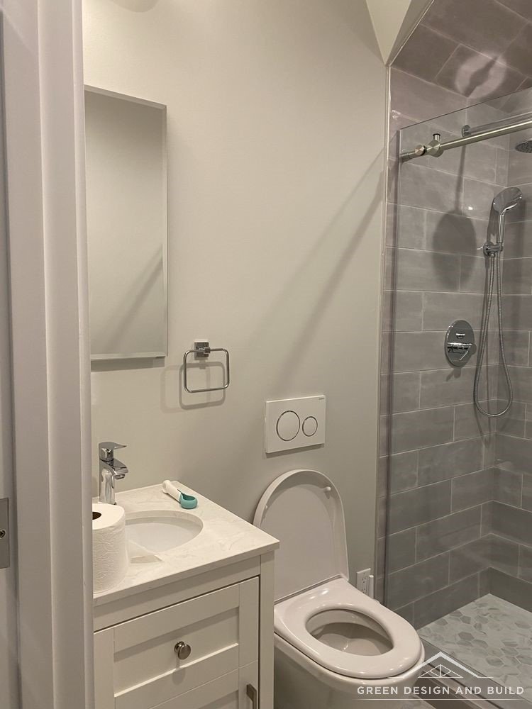 Second bathroom with a white shaker vanity beside a tiled walk-in shower in a Diamond Bar home