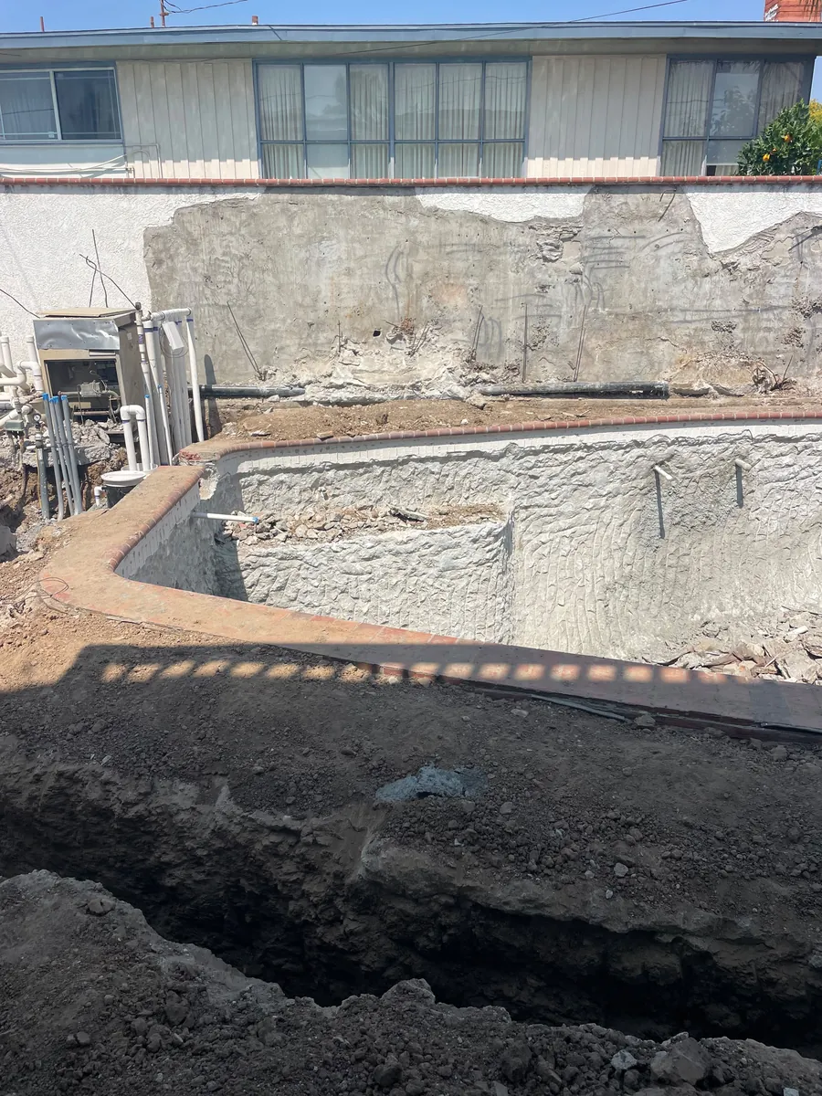 Rear yard excavated and graded before the pool shell was formed