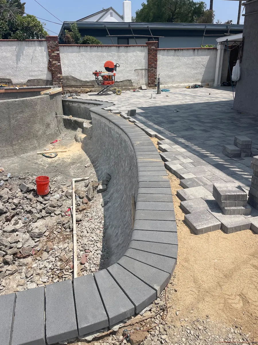 Paver border being set against the finished shell