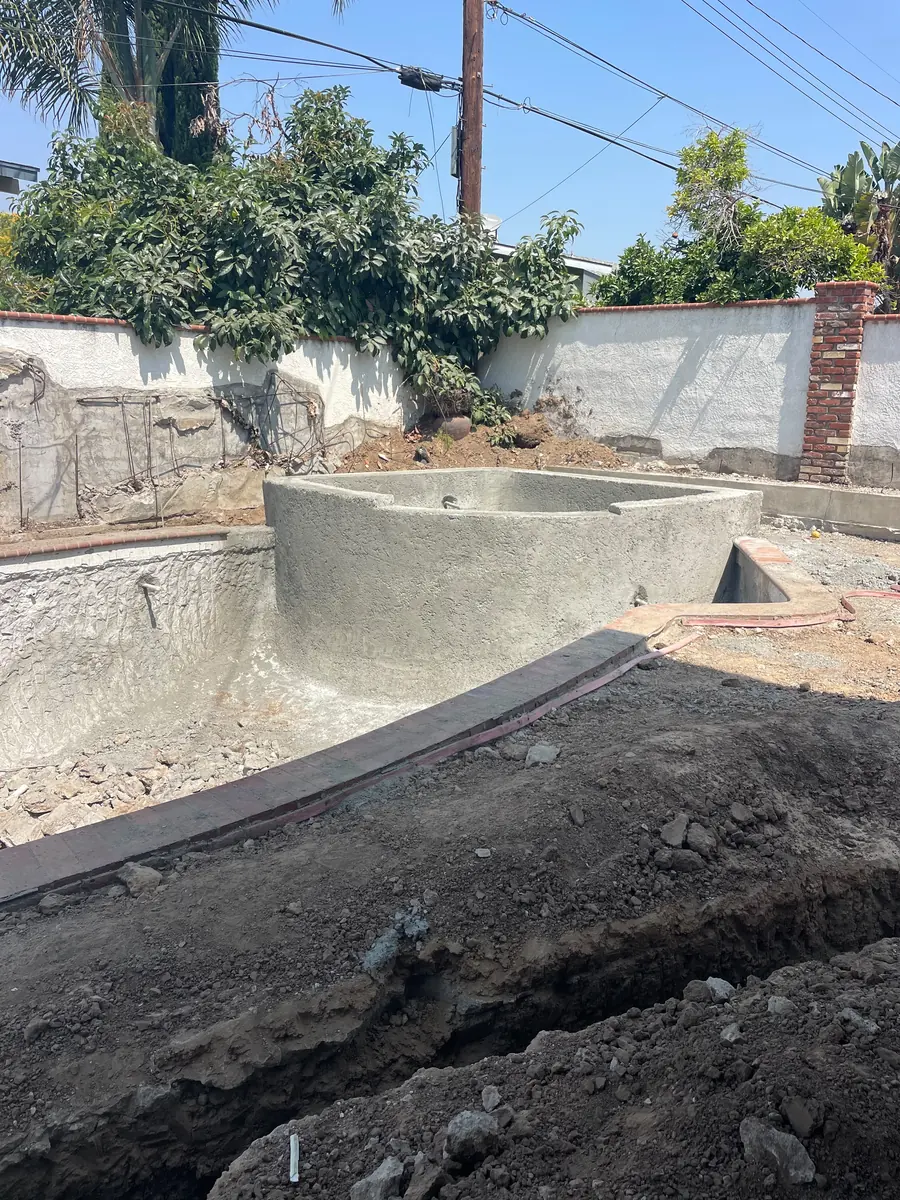 Pool shell with the raised spa formed integrally rather than added afterwards