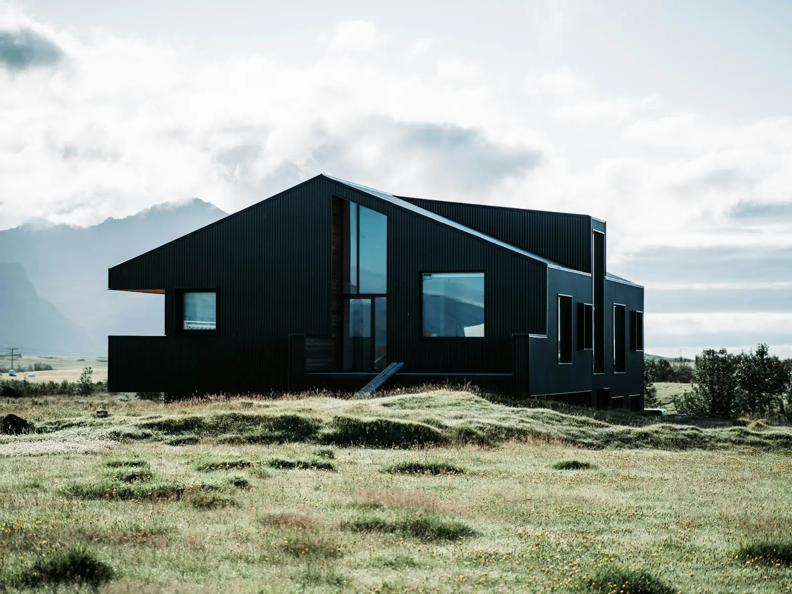 Modern black ADU with floor-to-ceiling glass windows built by Green Design and Build