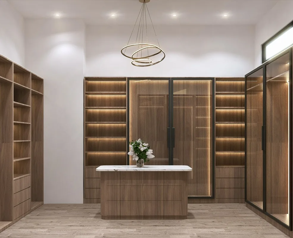 3D design rendering of a walk-in closet with lit walnut shelving, glass-front cabinets and a marble-topped island