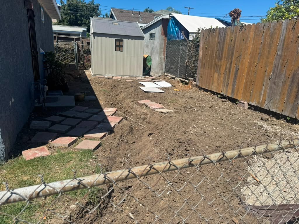Bare dirt side yard between the house and fence before paving, Anaheim