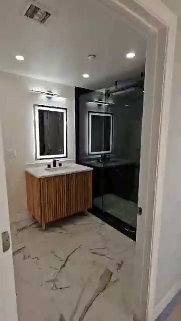 Bathroom: double vanity with lit mirrors — whole-home remodel in Encino, CA
