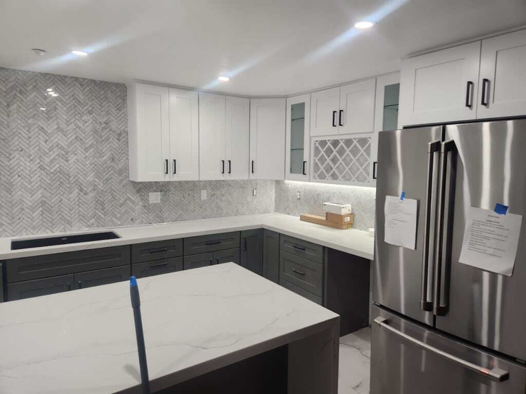 Kitchen finished: white cabinets, waterfall island — whole-home remodel in Encino, CA