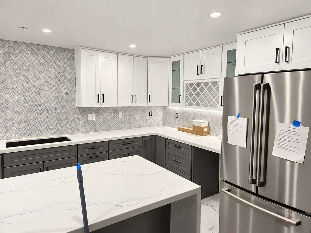 Finished kitchen with white cabinets and a quartz waterfall island in the Encino whole-home remodel