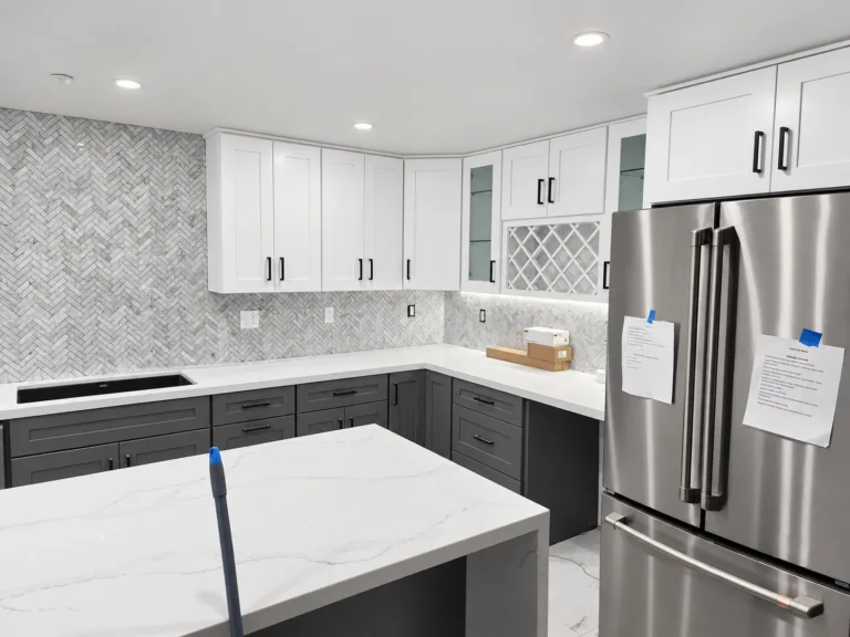 Kitchen finished: white cabinets, waterfall island — whole-home remodel in Encino, CA