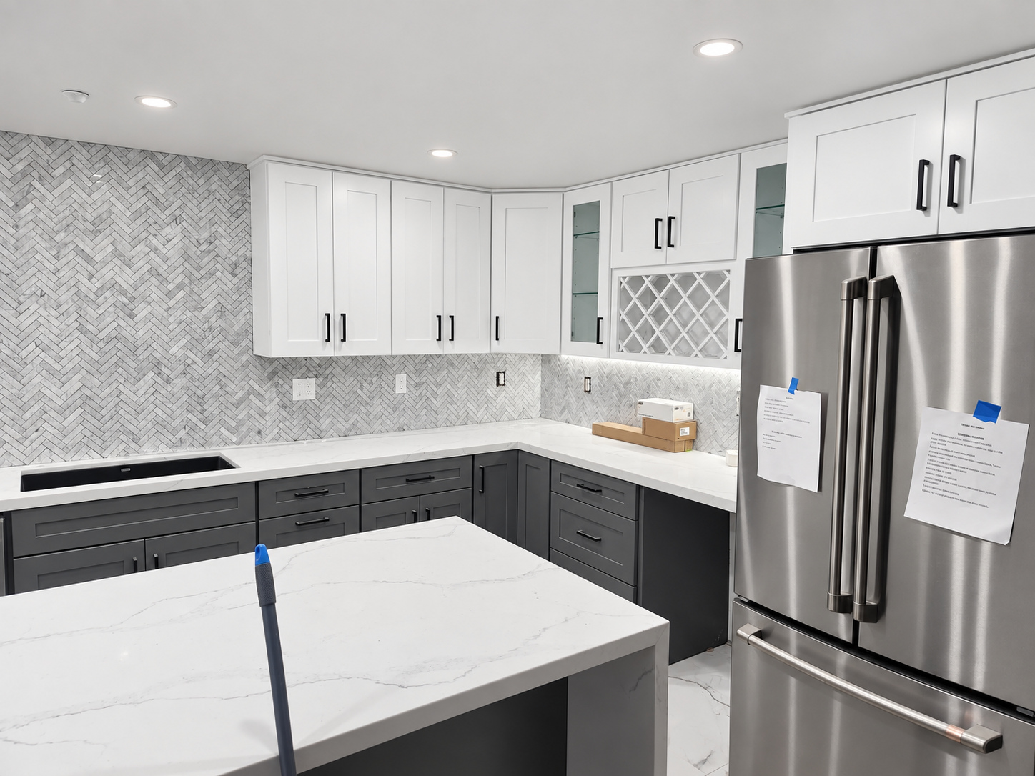 Kitchen finished: white cabinets, waterfall island — whole-home remodel in Encino, CA