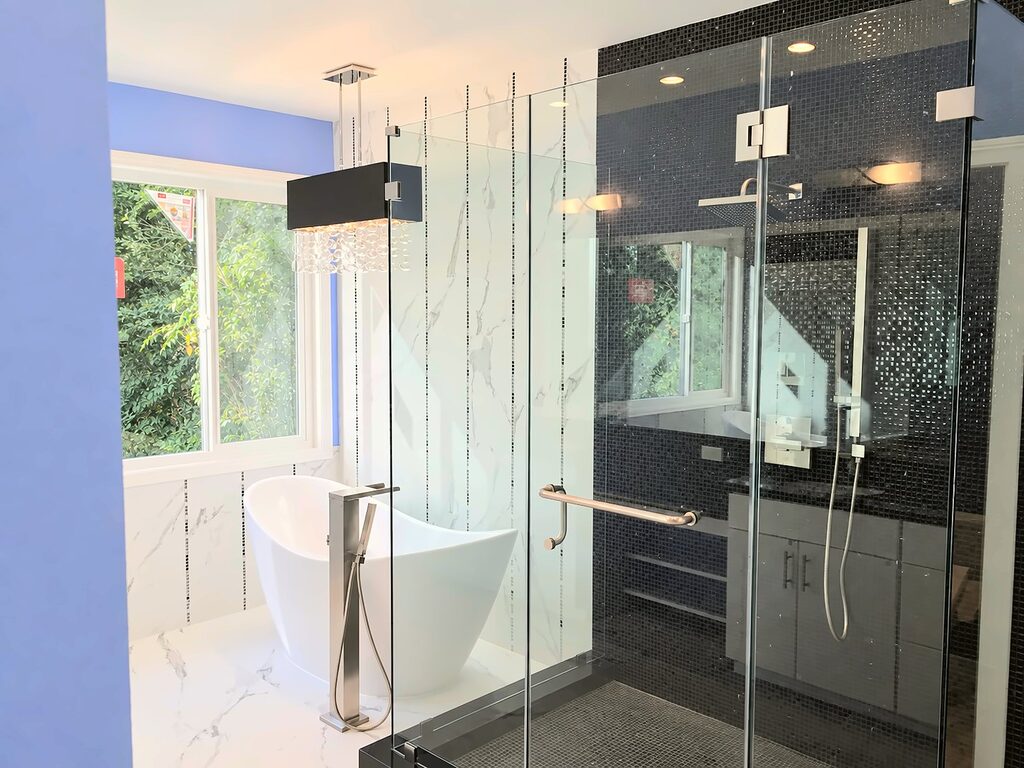 Freestanding tub and frameless glass shower in a remodeled primary bathroom in Inglewood