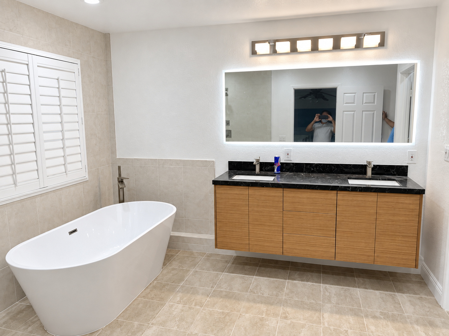 After: floating vanity and lit mirror — bathroom remodel in Irvine, CA