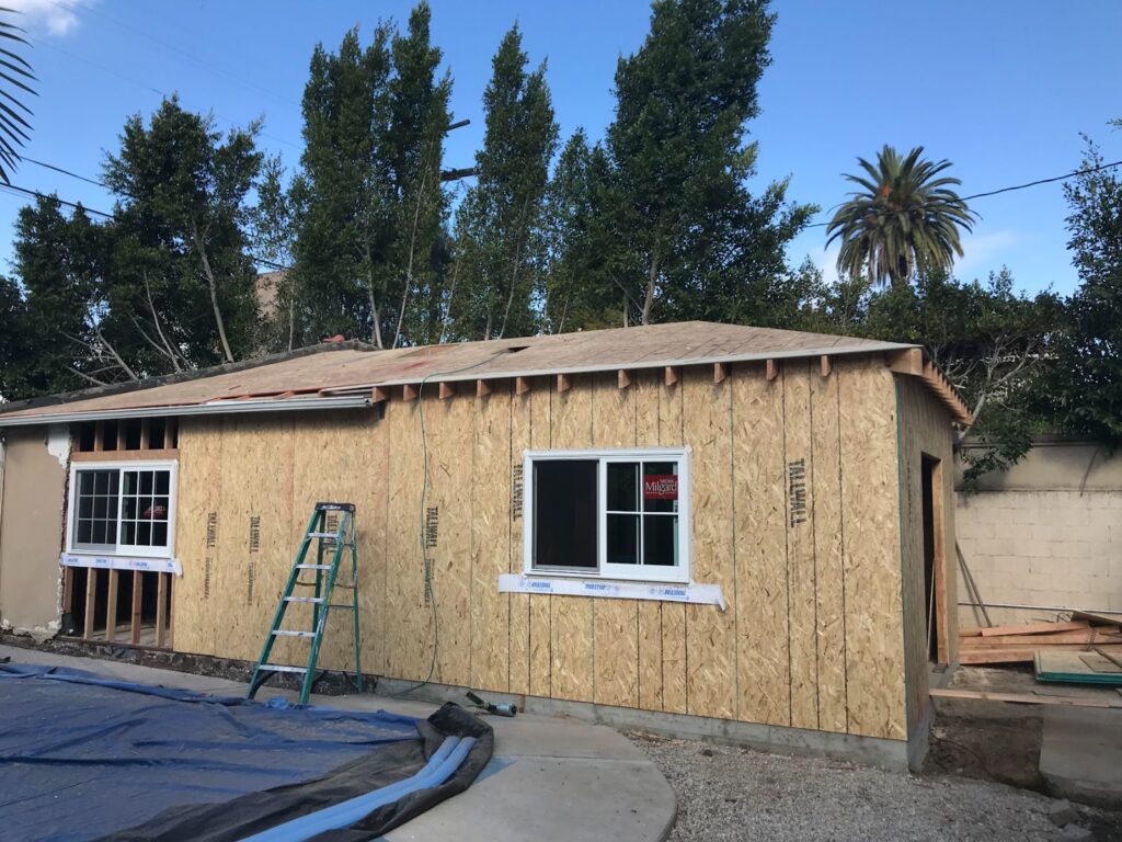 Sheathing on, new windows cut in — garage-to-ADU conversion in Los Angeles, CA