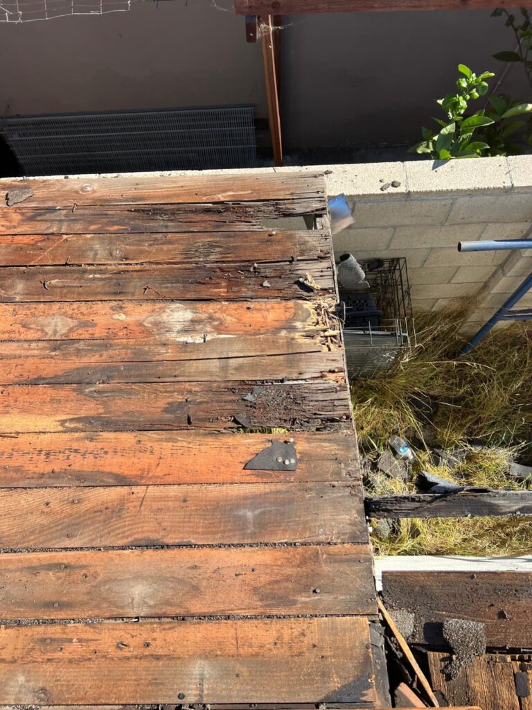 Before: rotted decking at the eave — roof replacement in Newport Beach, CA