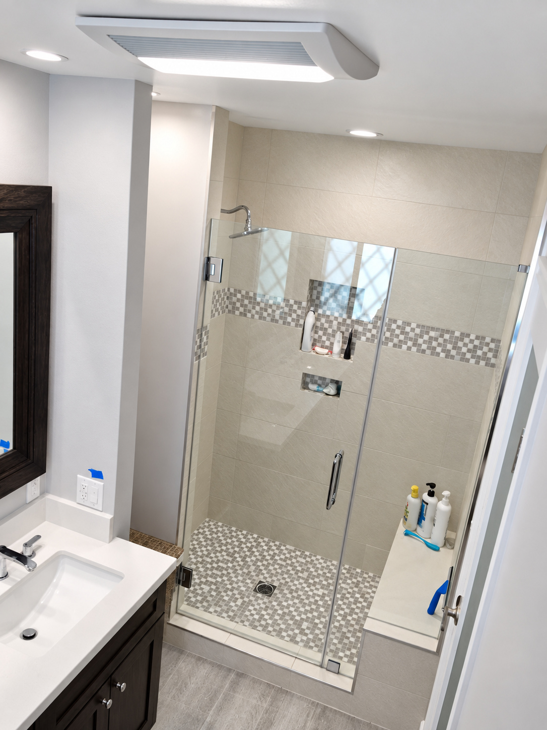 After: glass shower with accent band — bathroom remodel in Ontario, CA
