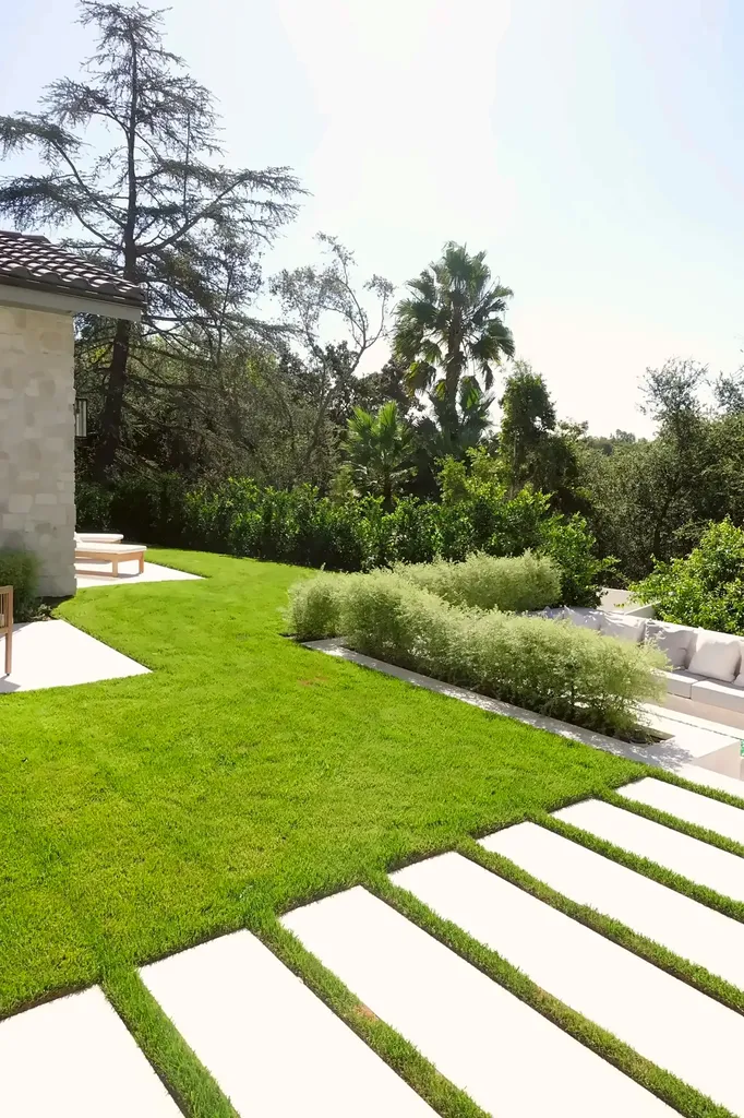 Artificial turf lawn with inset concrete step pads in a Hidden Hills backyard