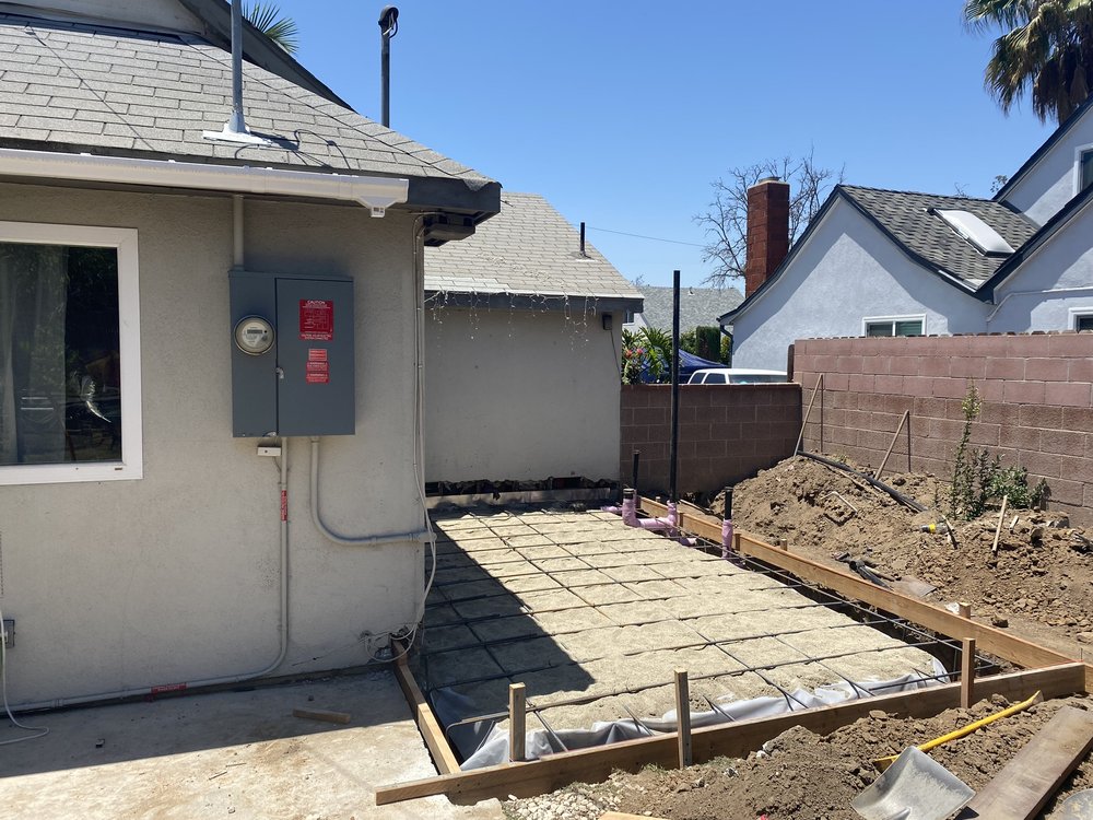 New concrete flatwork formed and poured alongside a room addition at a Montebello home
