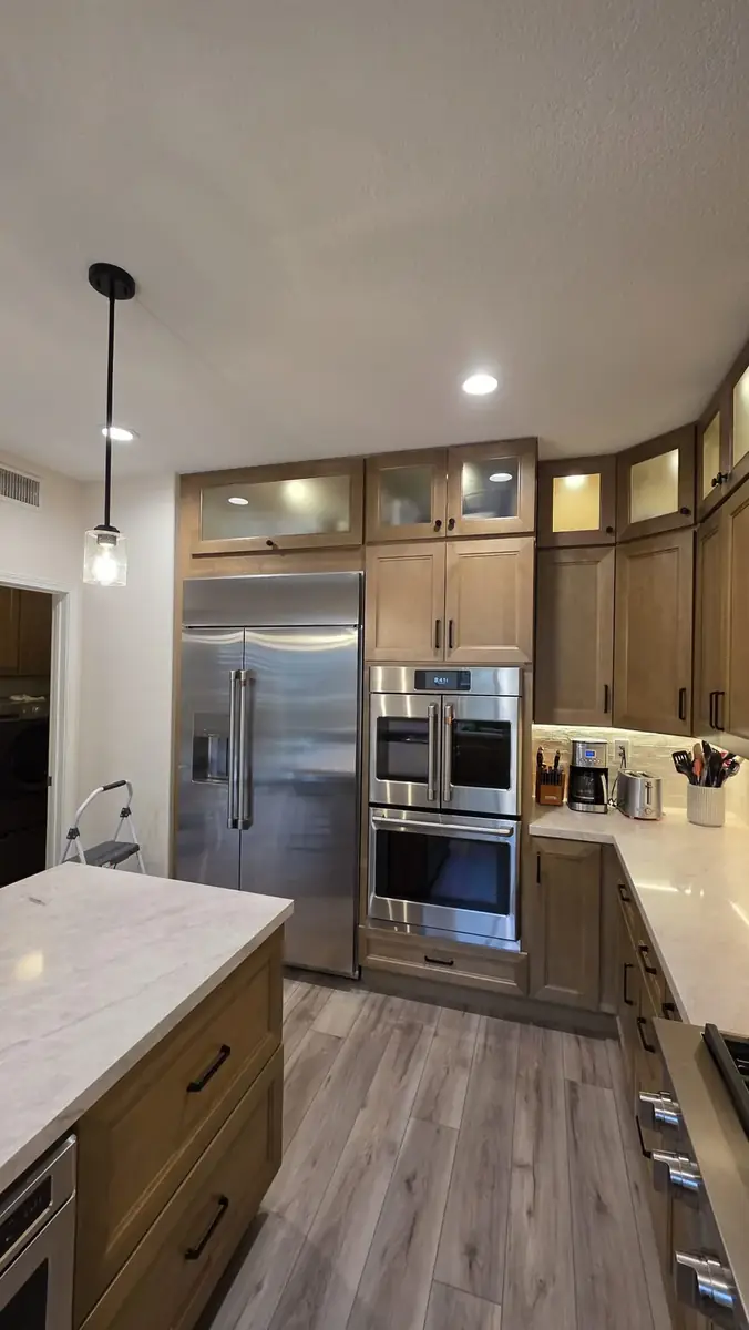 Built-in refrigerator beside a double wall oven &mdash; kitchen remodel in Pasadena, CA