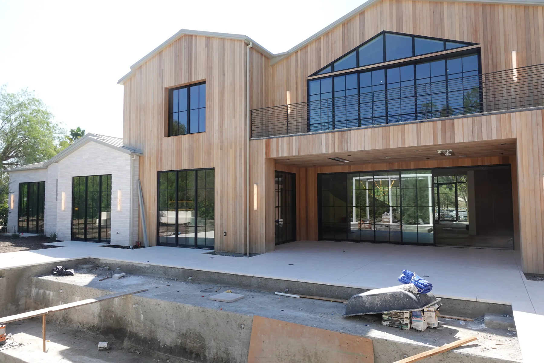 Pool shell under construction behind a new Hidden Hills home