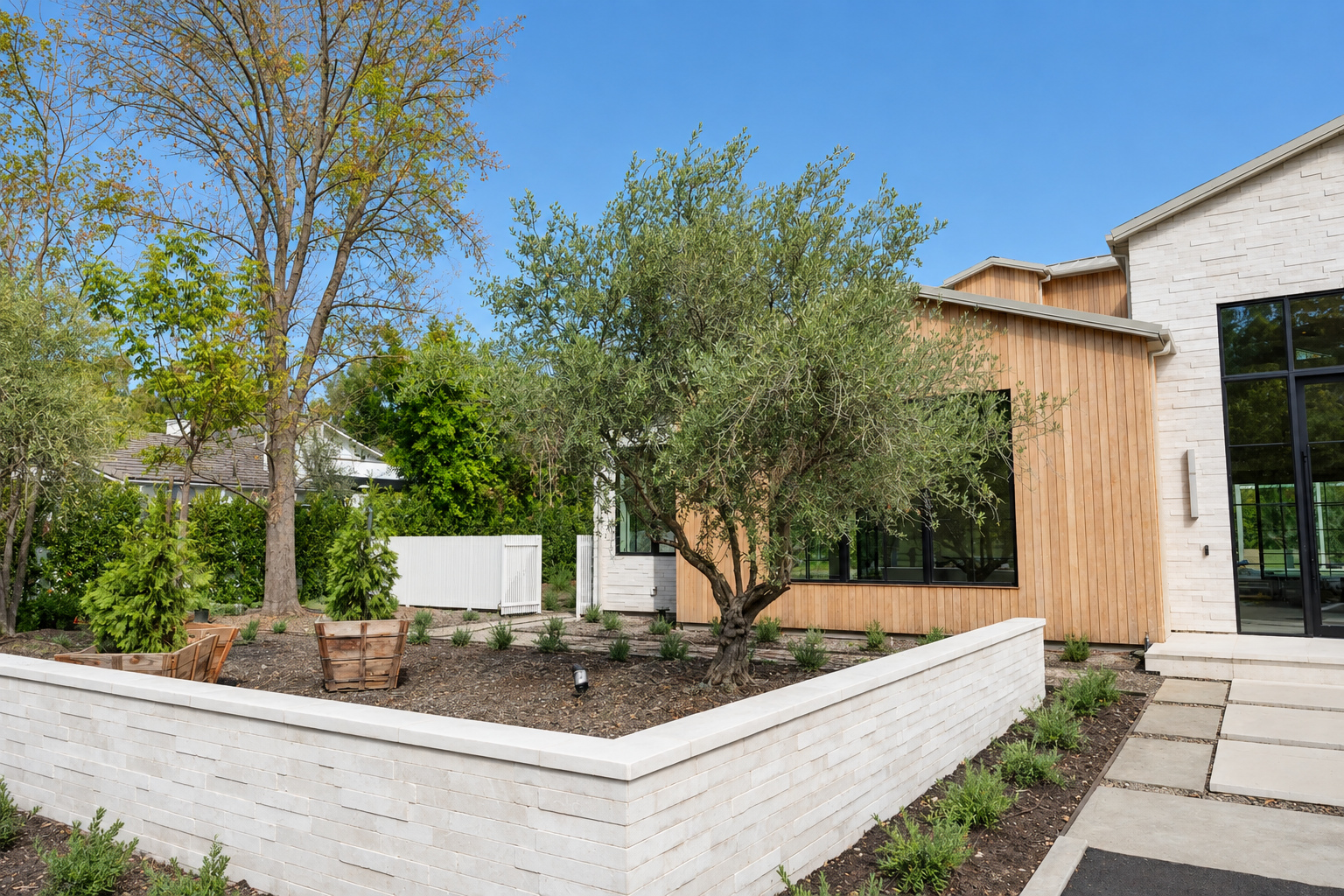 Cut stone retaining wall holding a raised planter, Hidden Hills