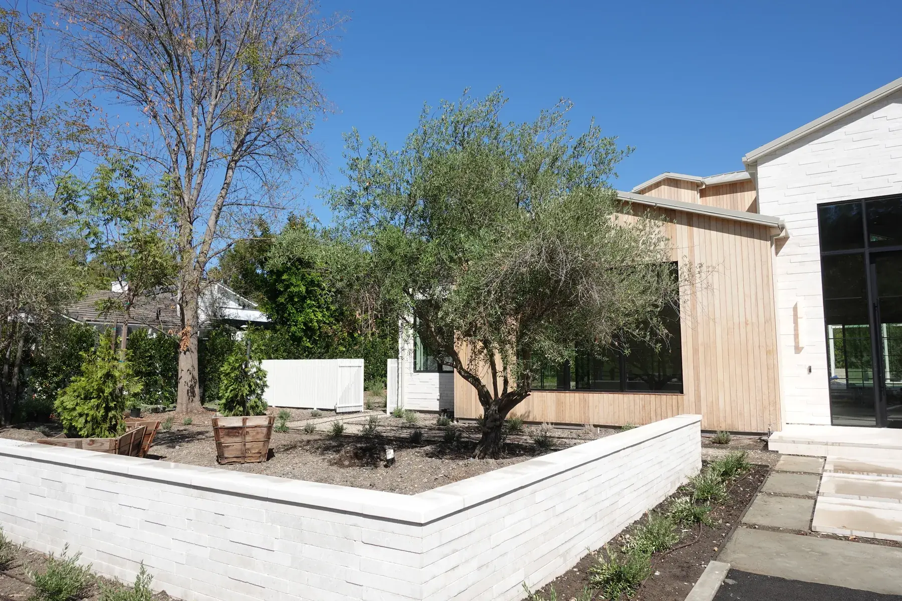 Cut stone retaining wall holding a raised planter, Hidden Hills