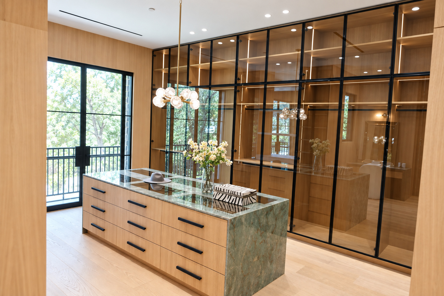 White oak plank flooring in a walk-in closet with glass-front cabinetry and a marble island, Hidden Hills