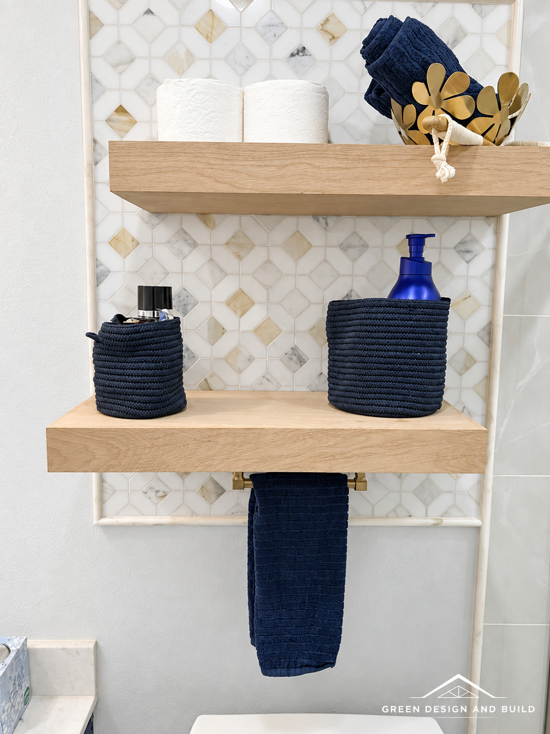 Floating white oak shelves against a mosaic tile accent wall in a West Hollywood bathroom