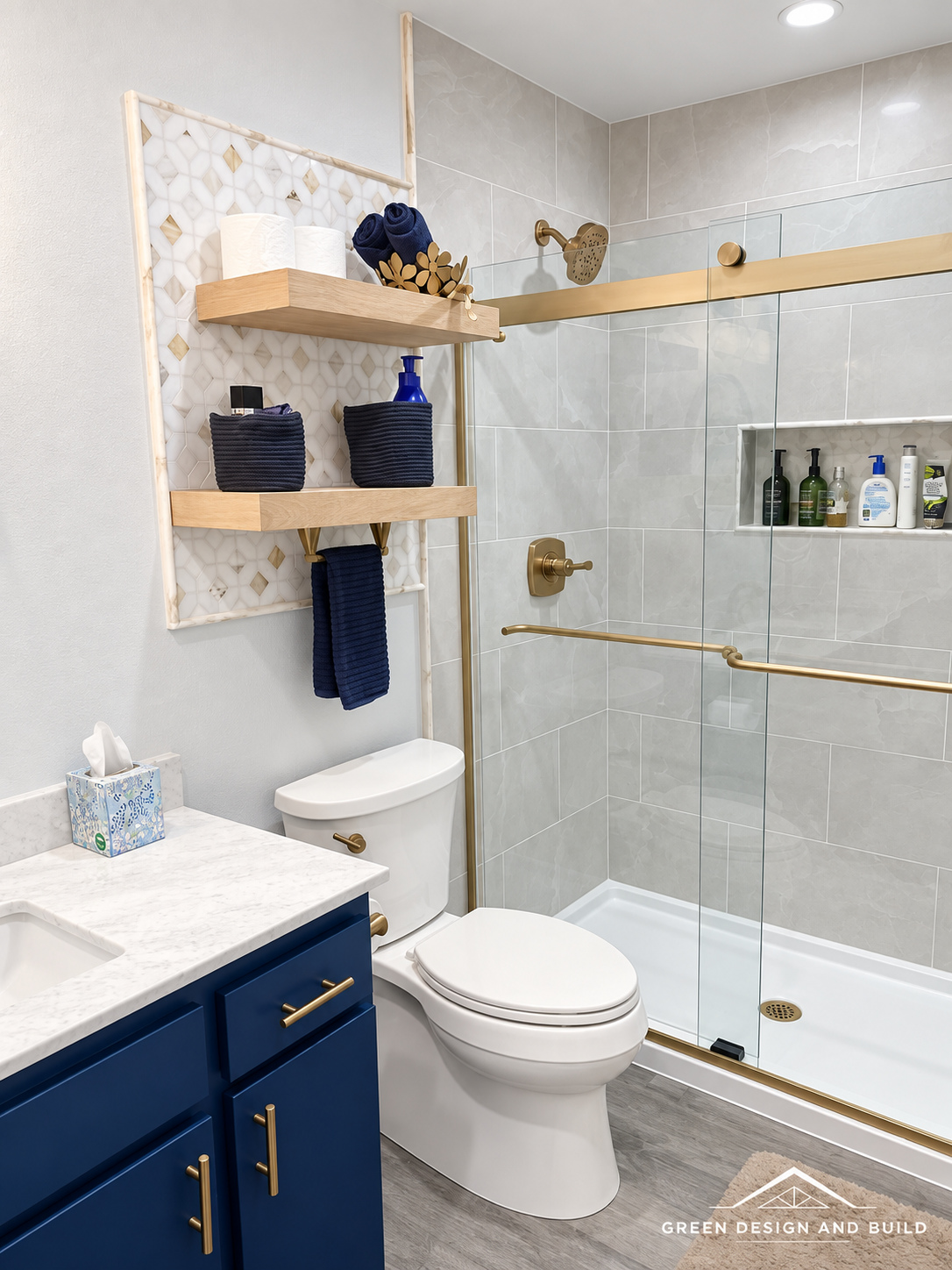 Tiled shower behind sliding glass beside a navy vanity in a remodeled West Hollywood bathroom