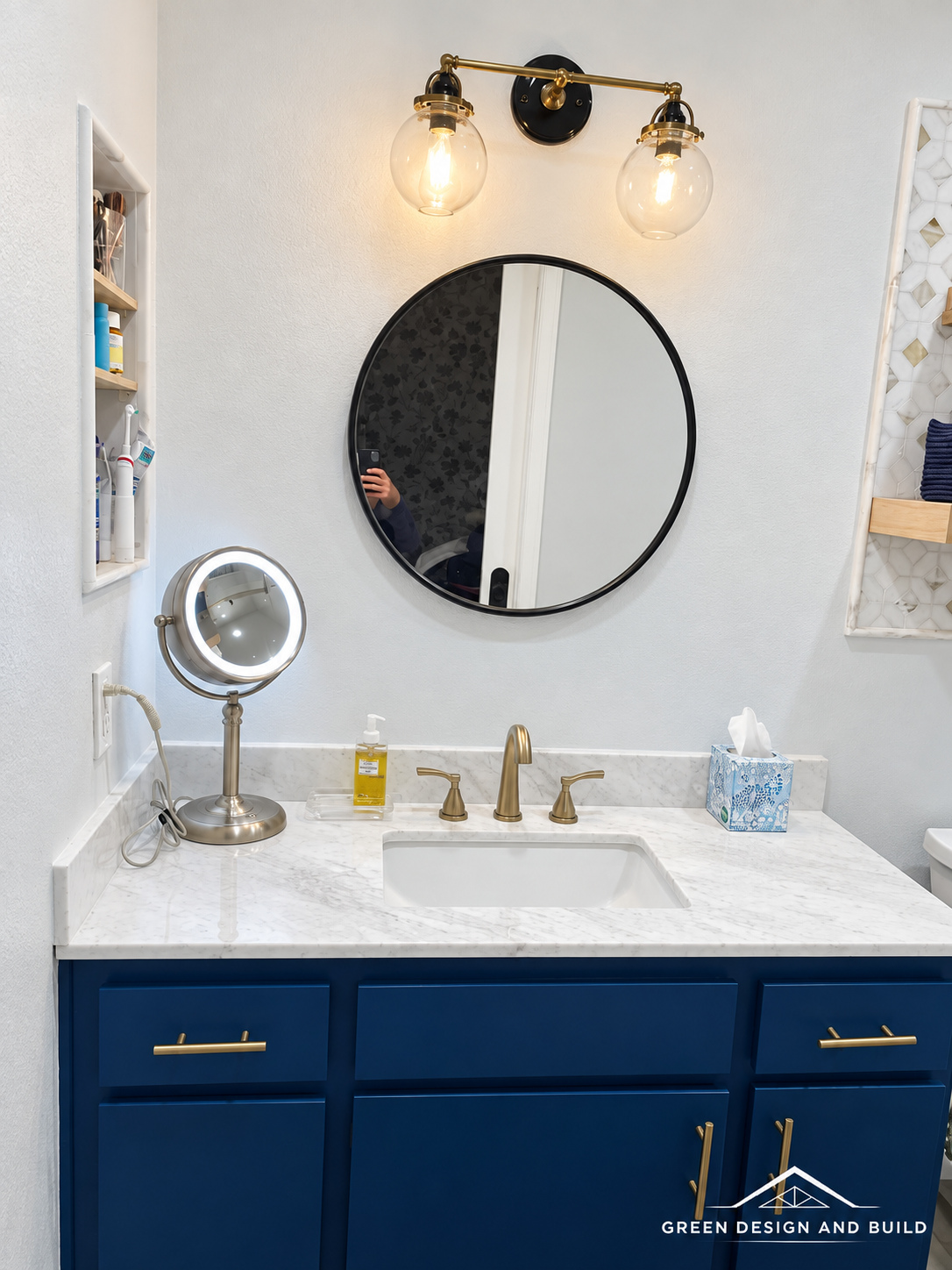 Marble-look counter, undermount basin and brass tap on a navy vanity in a West Hollywood bathroom