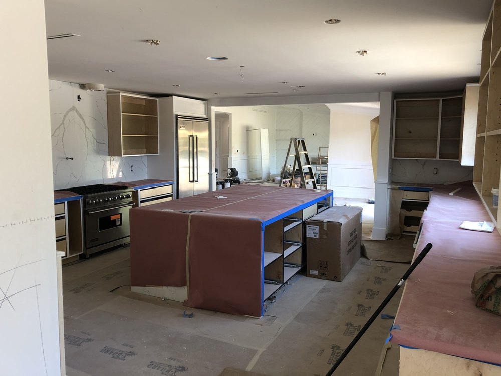 New kitchen island and range being installed during a Woodland Hills whole-home rebuild