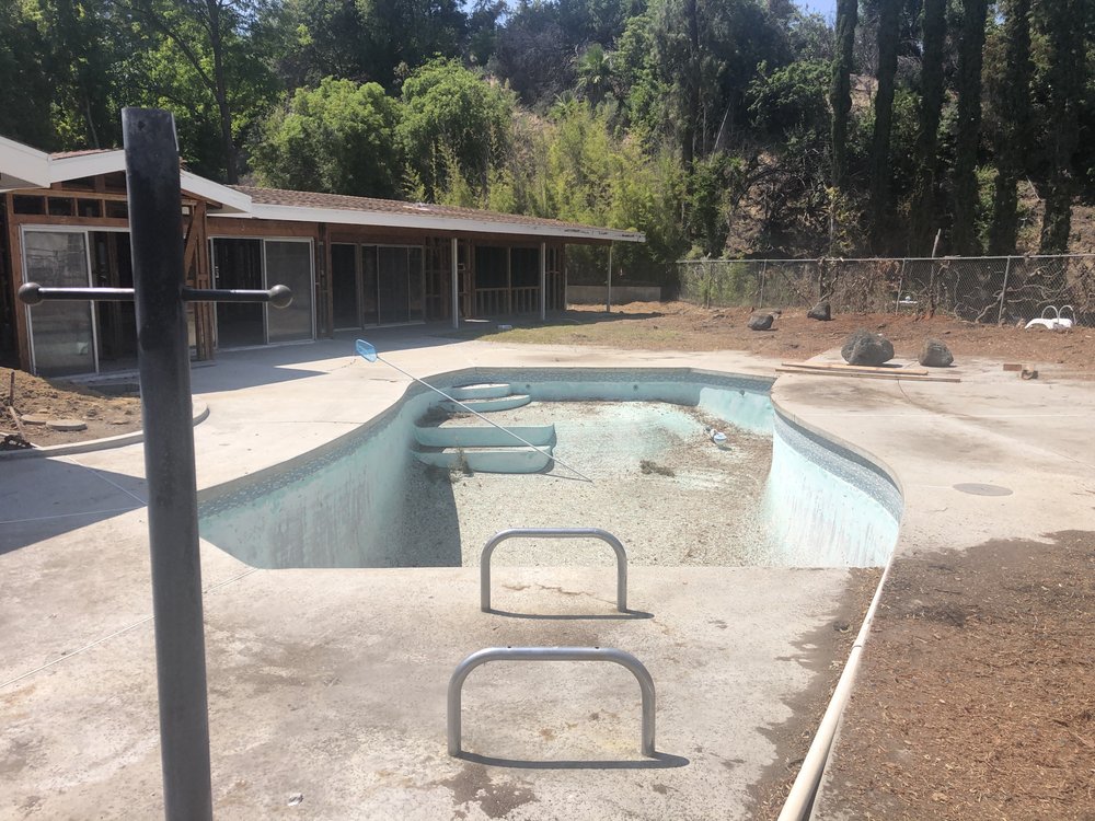 Existing swimming pool drained and stripped out during a Woodland Hills whole-home rebuild