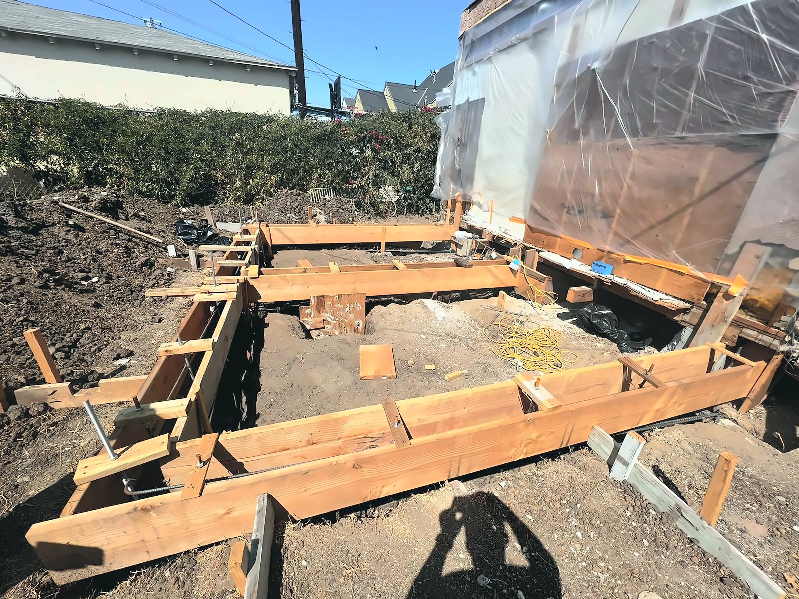 Footing forms and rebar set in a Los Angeles backyard before the foundation pour for an ADU